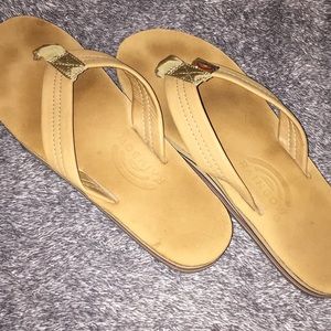 Lightly worn rainbow flip flops in light brown